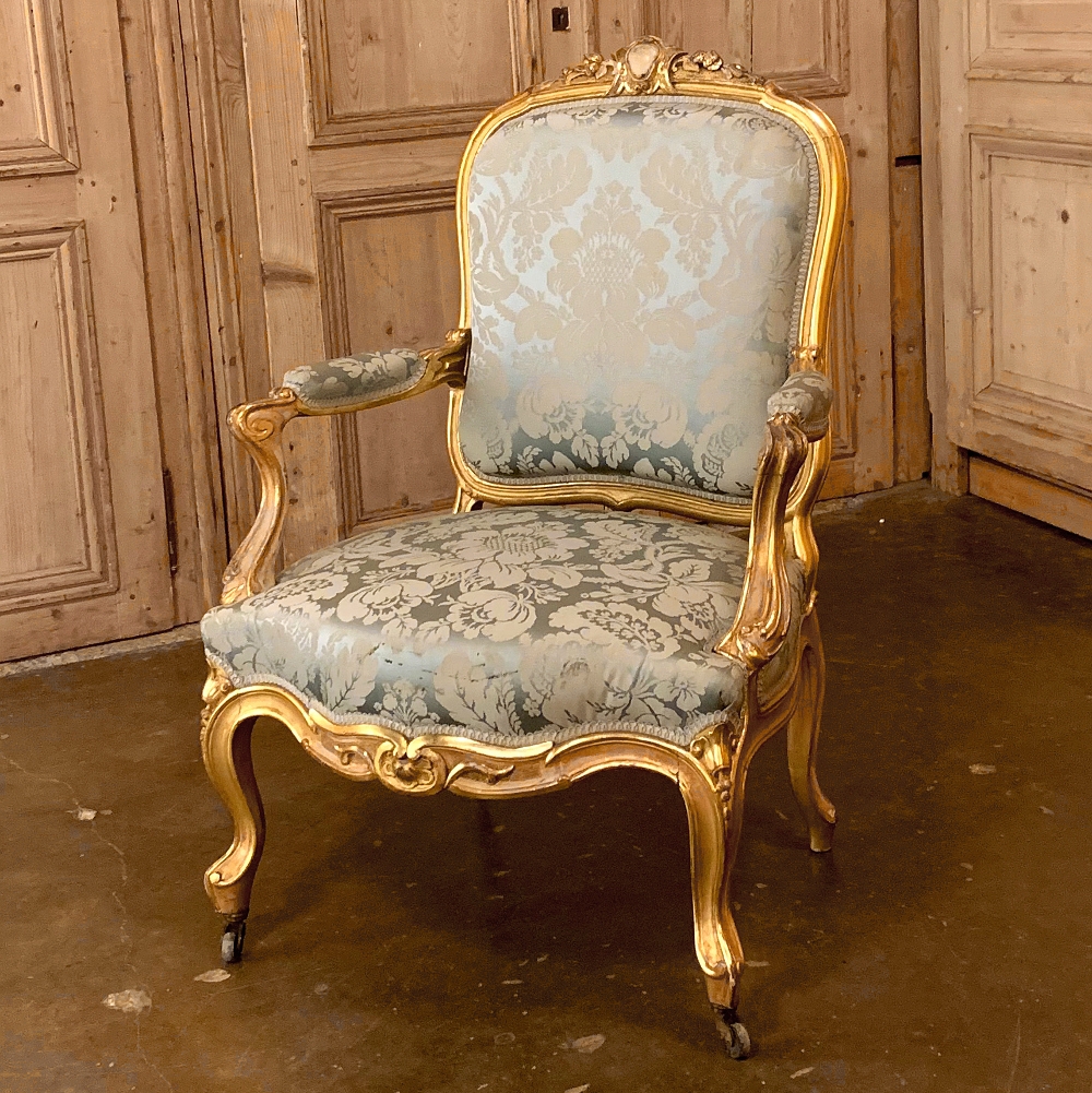 19th century French Louis XV style gilded wing chair.